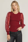 Solid round neck long sleeve top featuring sheer animal print sleeves