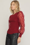 Solid round neck long sleeve top featuring sheer animal print sleeves